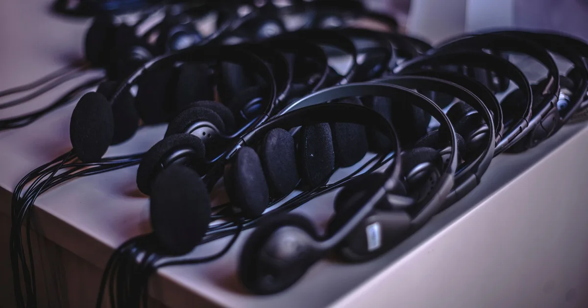 Rows of lightweight headphones laid out on a table